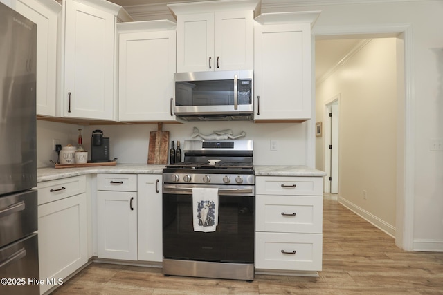 637 White Oak Xing, Swansboro, NC 28584 - kitchen with appliances with stainless steel finishes, light countertops, light wood-style floors, and ornamental molding
