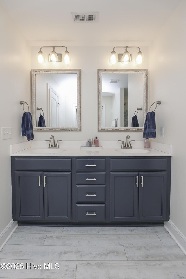 637 White Oak Xing, Swansboro, NC 28584 - full bathroom featuring double vanity and wood tiled floors