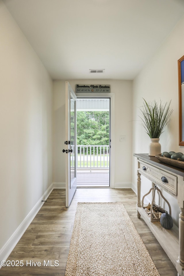 637 White Oak Xing, Swansboro, NC 28584 - doorway to outside featuring baseboards and wood finished floors