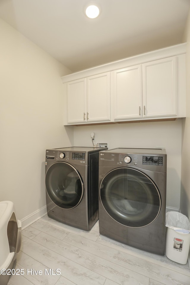 637 White Oak Xing, Swansboro, NC 28584 - laundry area featuring cabinet space, washer and clothes dryer, and light wood finished floors