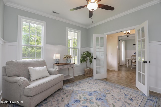 637 White Oak Xing, Swansboro, NC 28584 - living area with french doors, wood finished floors, ornamental molding, a wainscoted wall, and a decorative wall