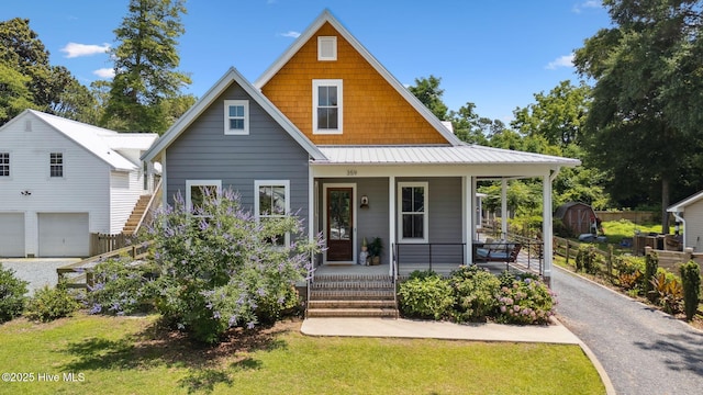 359 N Leak St, Southern Pines, NC 28387 - view of front of property featuring a porch, an outbuilding, driveway, and a front yard