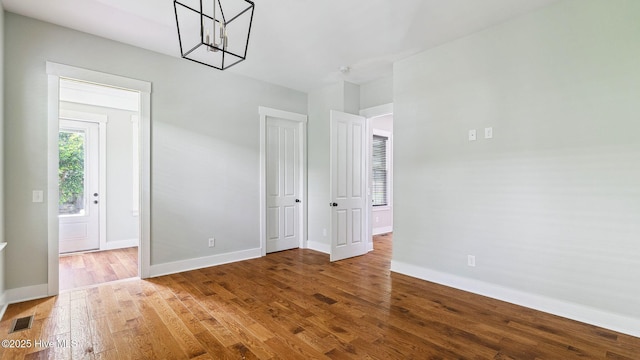 359 N Leak St, Southern Pines, NC 28387 - spare room with a chandelier, wood finished floors, and baseboards