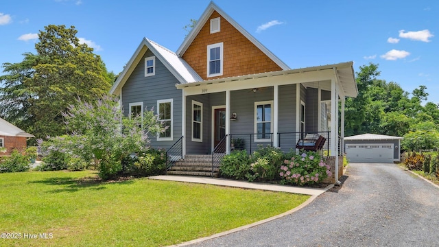 359 N Leak St, Southern Pines, NC 28387 - view of front of property with an outdoor structure, a front lawn, a porch, and a detached garage