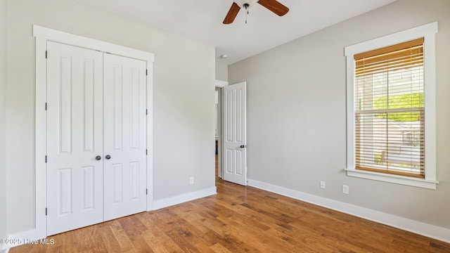 359 N Leak St, Southern Pines, NC 28387 - unfurnished bedroom with a closet, wood finished floors, baseboards, and ceiling fan