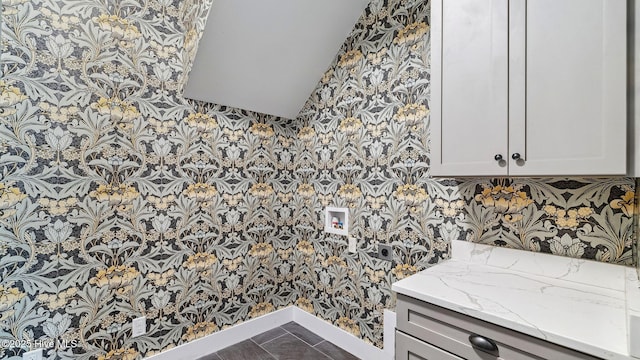 359 N Leak St, Southern Pines, NC 28387 - bathroom featuring wallpapered walls, baseboards, and lofted ceiling
