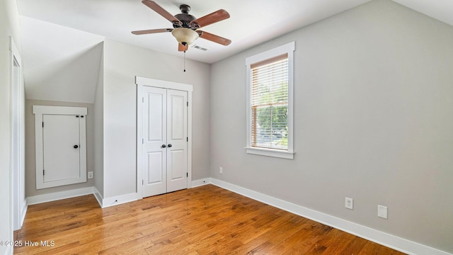 359 N Leak St, Southern Pines, NC 28387 - unfurnished bedroom with light wood finished floors, baseboards, a closet, and a ceiling fan