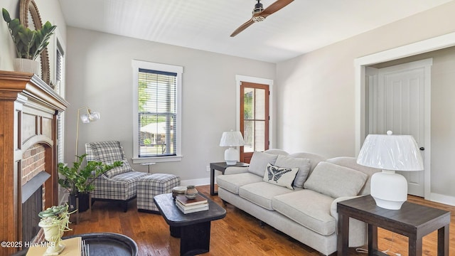 359 N Leak St, Southern Pines, NC 28387 - living area featuring a brick fireplace, a ceiling fan, wood finished floors, and baseboards