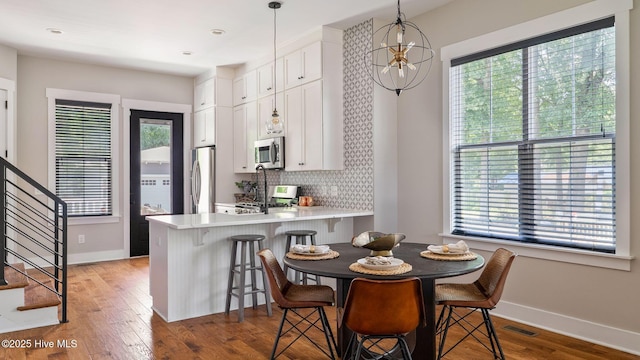 359 N Leak St, Southern Pines, NC 28387 - kitchen with stainless steel appliances, healthy amount of natural light, white cabinets, and baseboards
