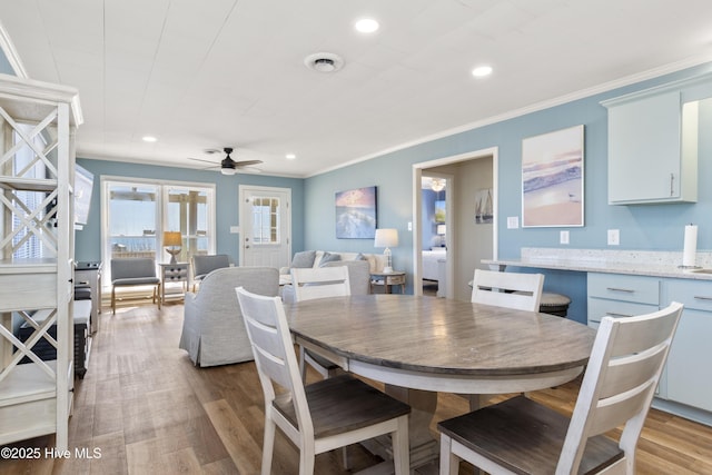 901 Ocean Dr, Emerald Isle, NC 28594 - dining area featuring a ceiling fan, light wood finished floors, ornamental molding, and recessed lighting