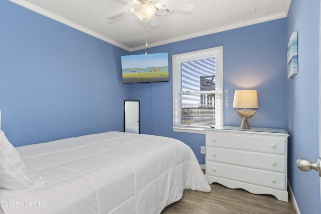 901 Ocean Dr, Emerald Isle, NC 28594 - bedroom with crown molding, wood finished floors, a ceiling fan, and baseboards