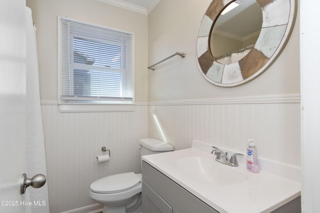 901 Ocean Dr, Emerald Isle, NC 28594 - bathroom featuring a wainscoted wall, vanity, ornamental molding, toilet, and curtained shower