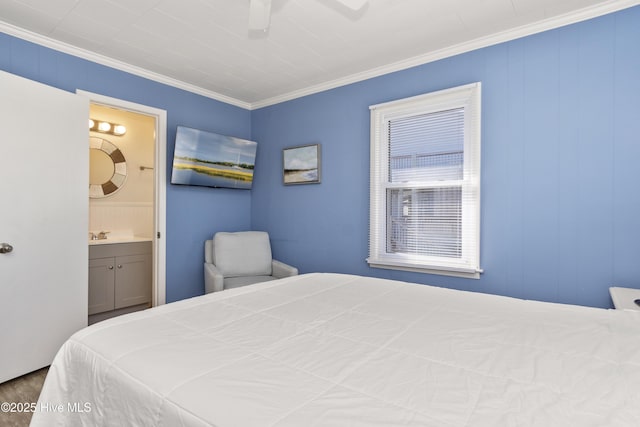 901 Ocean Dr, Emerald Isle, NC 28594 - bedroom featuring ornamental molding, connected bathroom, a ceiling fan, and wood finished floors