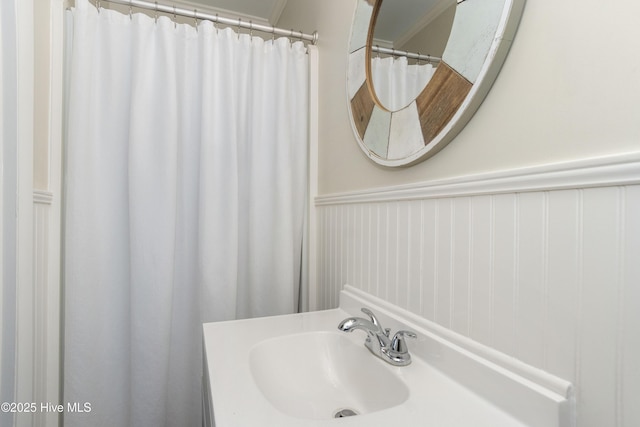 901 Ocean Dr, Emerald Isle, NC 28594 - bathroom with a wainscoted wall, vanity, and a shower with shower curtain