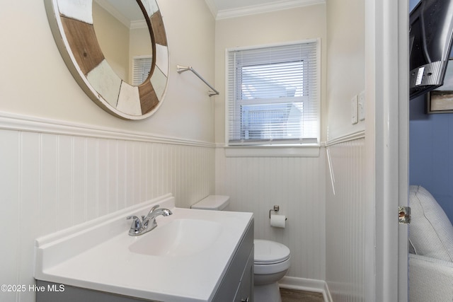 901 Ocean Dr, Emerald Isle, NC 28594 - bathroom featuring toilet, a wainscoted wall, vanity, and ornamental molding