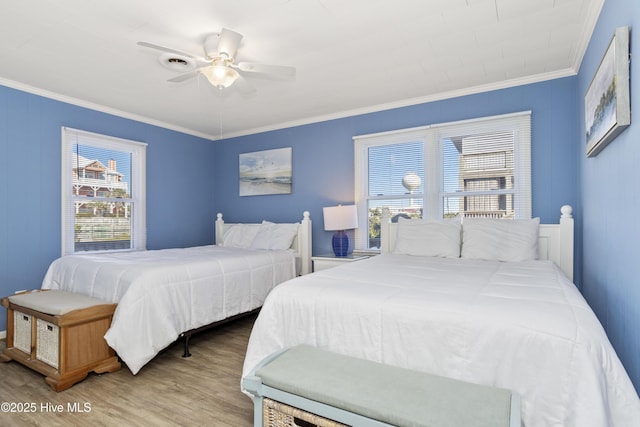 901 Ocean Dr, Emerald Isle, NC 28594 - bedroom with crown molding, wood finished floors, and a ceiling fan