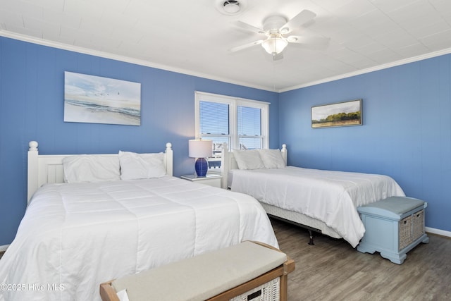 901 Ocean Dr, Emerald Isle, NC 28594 - bedroom with wood finished floors, crown molding, ceiling fan, and baseboards