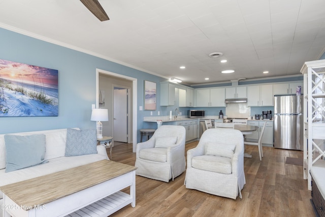 901 Ocean Dr, Emerald Isle, NC 28594 - living area with crown molding, recessed lighting, and wood finished floors