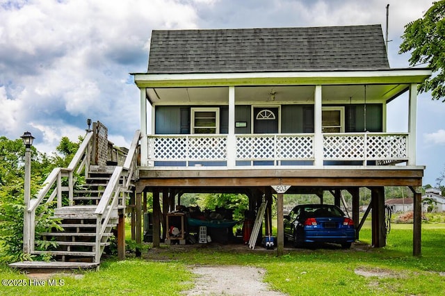 503 Vandemere Rd, Bayboro, NC 28515 - coastal inspired home featuring a carport, a shingled roof, and stairs