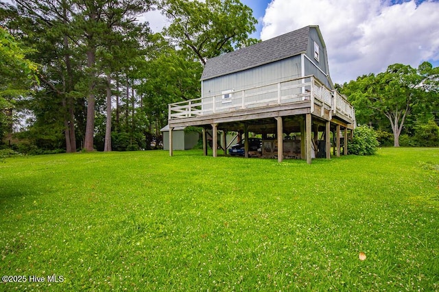 503 Vandemere Rd, Bayboro, NC 28515 - back of house featuring a shingled roof, a deck, a lawn, a gambrel roof, and a carport
