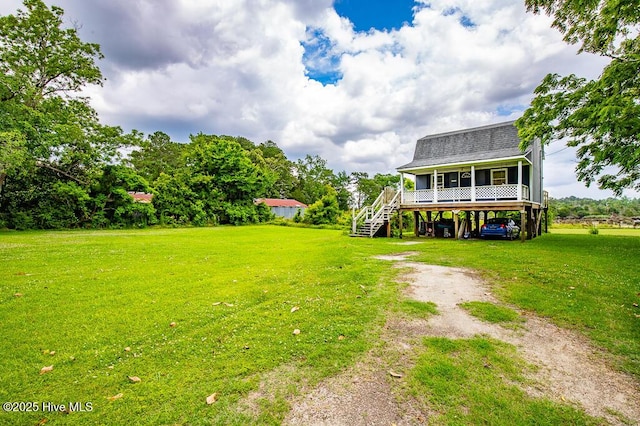 503 Vandemere Rd, Bayboro, NC 28515 - view of green lawn featuring a carport, dirt driveway, and stairs