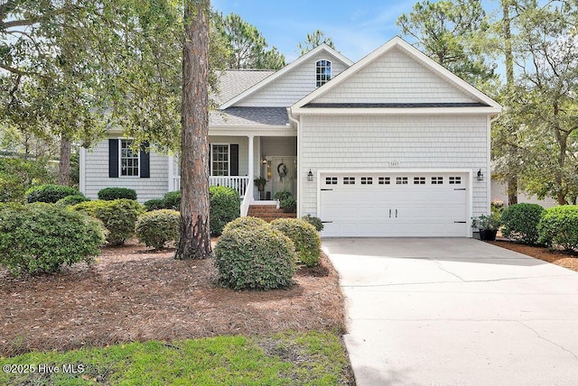 3853 Winding Vine Way, Southport, NC 28461 - view of front of home featuring an attached garage, concrete driveway, a porch, and roof with shingles