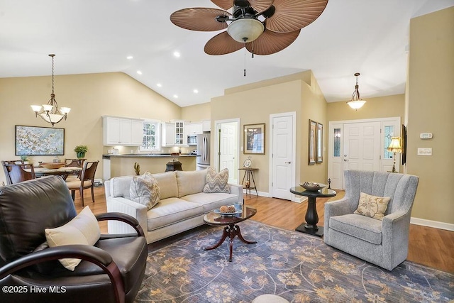3853 Winding Vine Way, Southport, NC 28461 - living room featuring light wood-style flooring, a ceiling fan, a chandelier, high vaulted ceiling, and recessed lighting