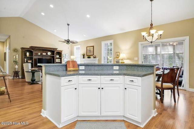 3853 Winding Vine Way, Southport, NC 28461 - kitchen featuring lofted ceiling, a chandelier, light wood finished floors, pendant lighting, and white cabinets