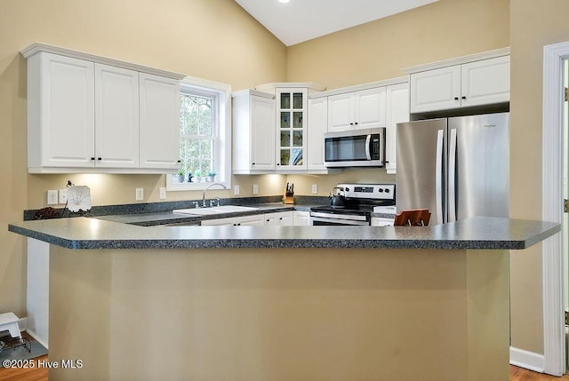 3853 Winding Vine Way, Southport, NC 28461 - kitchen featuring stainless steel appliances, dark countertops, and white cabinetry