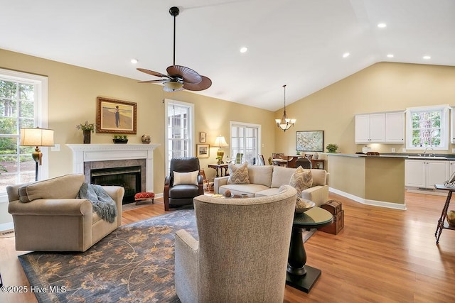 3853 Winding Vine Way, Southport, NC 28461 - living area featuring a high end fireplace, a chandelier, light wood-type flooring, recessed lighting, and ceiling fan