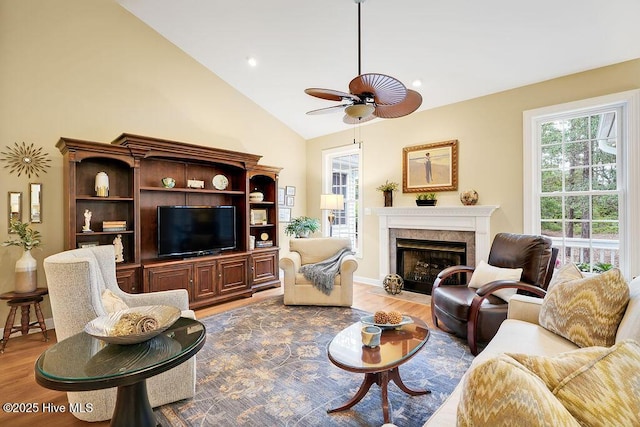 3853 Winding Vine Way, Southport, NC 28461 - living area with ceiling fan, light wood-style floors, a premium fireplace, and high vaulted ceiling