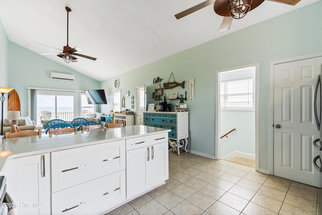 2310 New River Inlet Rd Unit 1, North Topsail Beach, NC 28460 - kitchen featuring ceiling fan, a wall unit AC, vaulted ceiling, open floor plan, and white cabinetry
