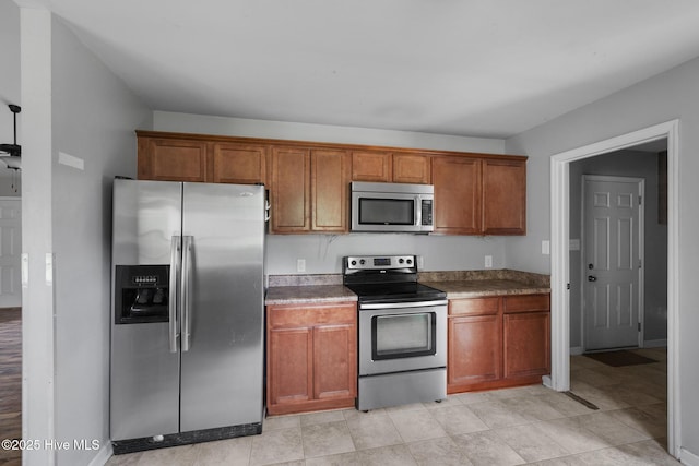 308 Big Tree Ln, Chinquapin, NC 28521 - kitchen featuring stainless steel appliances and brown cabinets