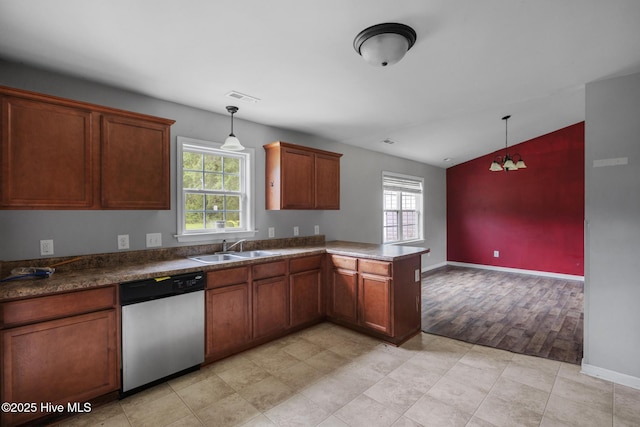 308 Big Tree Ln, Chinquapin, NC 28521 - kitchen with stainless steel dishwasher, a peninsula, lofted ceiling, hanging light fixtures, and brown cabinets