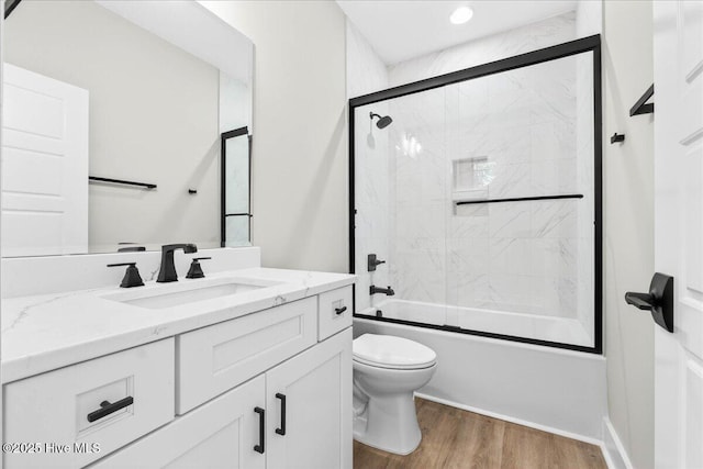 1711 Hemingway Dr SW, Ocean Isle Beach, NC 28469 - full bathroom with toilet, vanity, wood finished floors, and combined bath / shower with glass door