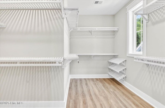 1711 Hemingway Dr SW, Ocean Isle Beach, NC 28469 - walk in closet with wood finished floors