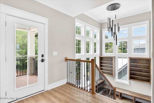 1711 Hemingway Dr SW, Ocean Isle Beach, NC 28469 - staircase with a chandelier, wood finished floors, healthy amount of natural light, and baseboards