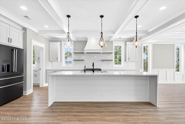 1711 Hemingway Dr SW, Ocean Isle Beach, NC 28469 - kitchen with high quality fridge, open shelves, backsplash, white cabinetry, and beamed ceiling