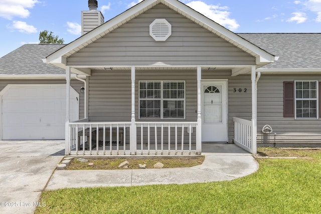 302 Josie Ct, Hubert, NC 28539 - view of front facade featuring covered porch, concrete driveway, a garage, roof with shingles, and a chimney