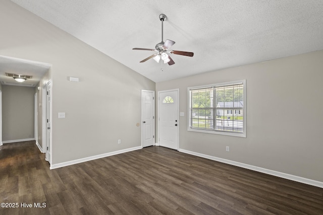 302 Josie Ct, Hubert, NC 28539 - foyer entrance with dark wood-style flooring, vaulted ceiling, a ceiling fan, and a textured ceiling