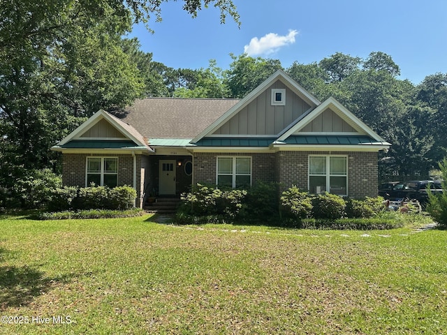 2790 Scotts Hill Loop Rd, Wilmington, NC 28411 - craftsman house featuring a front yard, brick siding, and board and batten siding