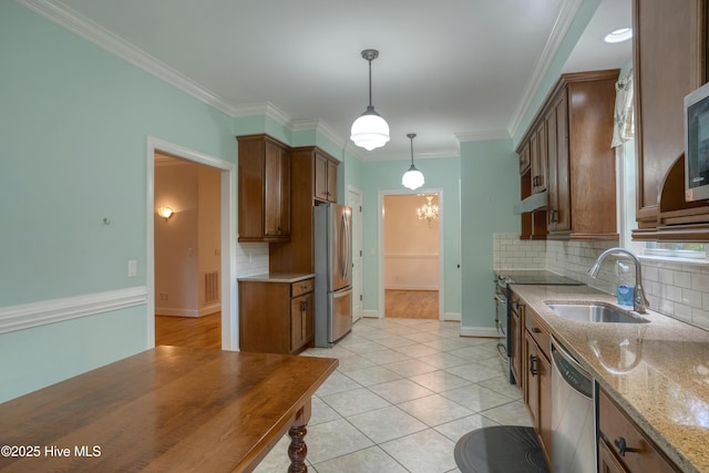 2790 Scotts Hill Loop Rd, Wilmington, NC 28411 - kitchen featuring stainless steel appliances, decorative backsplash, light stone countertops, under cabinet range hood, and hanging light fixtures