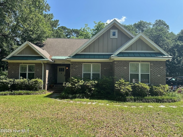 2790 Scotts Hill Loop Rd, Wilmington, NC 28411 - view of front of home with board and batten siding, brick siding, and a front lawn