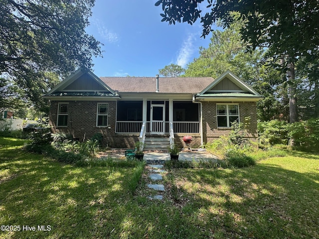 2790 Scotts Hill Loop Rd, Wilmington, NC 28411 - view of front facade featuring brick siding and a front lawn