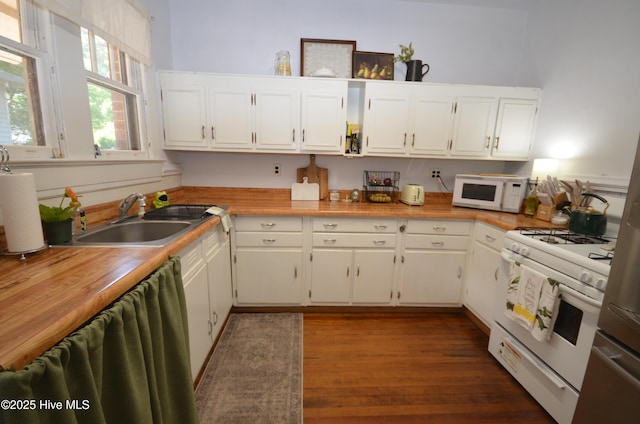 1409 E Walnut St, Goldsboro, NC 27530 - kitchen featuring white appliances, a sink, dark wood finished floors, and white cabinets