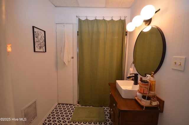1409 E Walnut St, Goldsboro, NC 27530 - bathroom featuring vanity, curtained shower, and baseboards