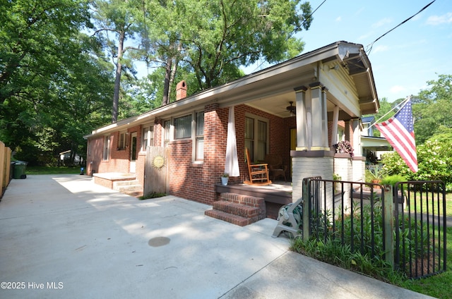 1409 E Walnut St, Goldsboro, NC 27530 - view of front of property featuring brick siding, ceiling fan, a porch, and a chimney