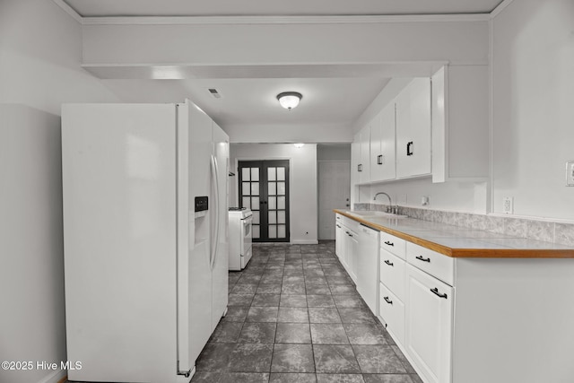 822 Chattawka Ln, New Bern, NC 28560 - kitchen featuring white appliances, french doors, white cabinetry, and a sink