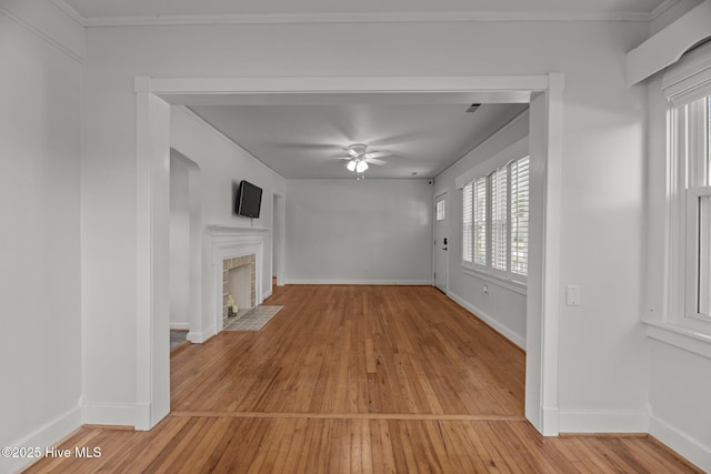 822 Chattawka Ln, New Bern, NC 28560 - unfurnished living room with light wood finished floors, ceiling fan, a fireplace with flush hearth, and baseboards