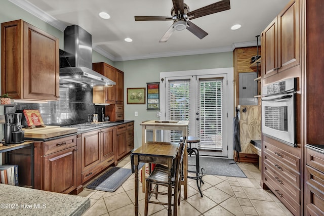 2008 Market St, Wilmington, NC 28403 - kitchen with oven, wall chimney exhaust hood, recessed lighting, backsplash, and ceiling fan